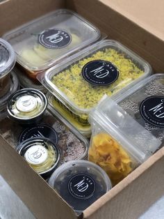 an open box filled with different types of food and containers on top of each other