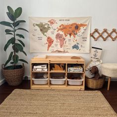 a room with a map on the wall and some toys in baskets next to it