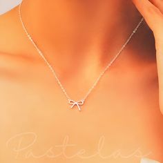 This dainty and adjustable necklace is the perfect gift for her, a timeless expression of love and appreciation.  Charming and cute, our Dainty Sterling Silver Bow Necklace features a beautiful silver bow pendant on a delicate silver chain.  Sterling Silver is hypoallergenic and Nickel free so no skin irritation or allergies. It is also very durable to last for years to come. Silver jewellery can be adapted to any look, any style, and any occasion. Like a well-established neutral, silver jewelle Adjustable Clavicle Chain Necklace As Gift For Her, Cute Adjustable Clavicle Chain Necklace, Adjustable Clavicle Chain Charm Necklaces For Gift, Cute Clavicle Chain Necklace For Mother's Day, Adjustable Dainty Charm Necklace As Gift, Elegant Charm Necklaces With Adjustable Chain For Gifts, Elegant Adjustable Charm Necklace As Gift For Her, Simple Wedding Charm Necklace, Delicate Adjustable Necklaces As Gift For Her