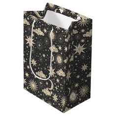 a black shopping bag with stars and moon designs