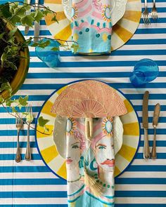 the table is set with colorful plates and utensils