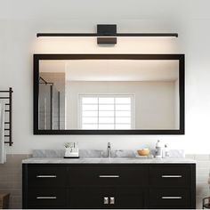 a bathroom vanity with two sinks and a large mirror over the sink in front of it