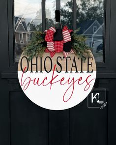 a sign that says, ohio state buckeyes hangs on the front door