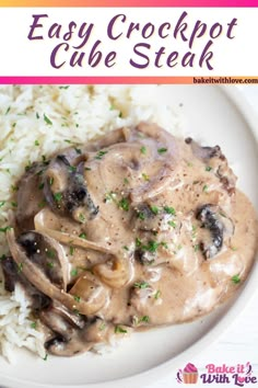 a white plate topped with rice and mushrooms covered in gravy on top of it