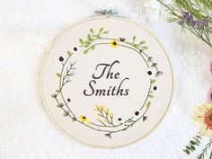 a cross stitch pattern with the words'the smiths'on it next to flowers