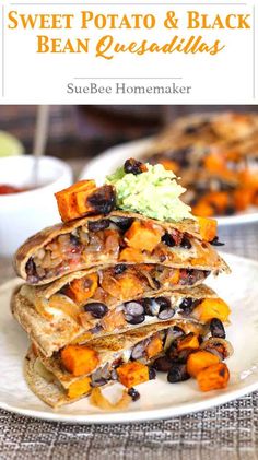 a stack of quesadillas with black beans and guacamole on top