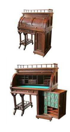 an old fashioned desk with two drawers and a green table cloth on the bottom shelf