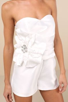 Make a statement in luxe style with the Lulus Feeling Incredible White Taffeta Applique Strapless Romper! Sleek woven taffeta shapes a sweetheart neckline (with hidden no-slip strips) and a strapless, pleated bodice with supportive side boning and an oversized, floral-like three-dimensional applique with sparkling rhinestone accents at the center. Fitted waist sits atop relaxed shorts. Hidden back zipper/clasp. Fit: This garment fits true to size. Length: Above mid-thigh. Size medium measures 24 White Bachelorette Party Dress, Dimensional Applique, 3d Applique, Bachelorette Party Dress, Casual Formal Dresses, Rehearsal Dinner Dresses, Luxe Style, Wedding Reception Dress, Lulu Fashion