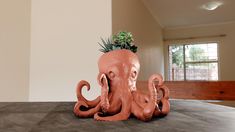 an octopus planter sitting on top of a table in the middle of a room