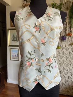 "This vest is so beautiful with very refined pastel colors  Has a delicate look Equestrian pattern with belts and flowers  Pastel colors: dusty pink, purple, ochre, green on pastel gray background  Silk 💯  Beautiful natural shell buttons  Elastic waist in the back  Size S Approximate measurements are taken flat  Armpit to armpit 17\" Waist 15\" Length in the 20\", in the front 22\" Excellent condition" Pastel Gray, Flowers Pastel, Silk Vest, Pastel Grey, Beaded Sweater, Vintage Inspired Dresses, Shell Buttons, Vest Outfits, Future Fashion