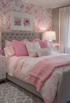 a bedroom decorated in pink and white with a large bed