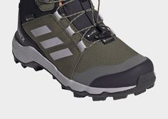 a pair of hiking shoes with laces on the outstep and soles