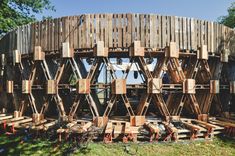 a circular structure made out of wooden planks