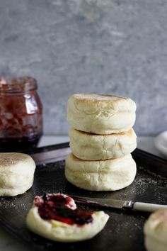 some biscuits and jam on a black tray