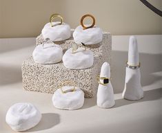 there are several white objects on the table and one is made out of clay with gold rings