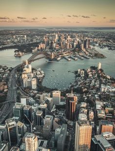 an aerial view of sydney, australia with the city in the foreground and the river running through it