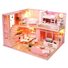 a pink doll house with furniture and stairs