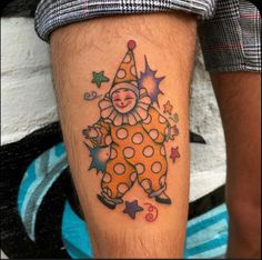 a clown tattoo on the leg of a man with stars around his ankles and feet