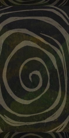 an image of a spiral design in black and green colors with white swirls on it