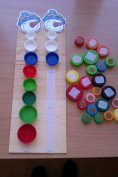 the table is set up with different colored plates and spoons on top of it