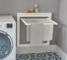 a washer and dryer sitting next to each other in a room with gray walls