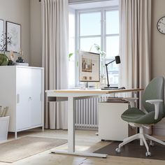 an office with a desk and chair in front of a window that has curtains on the windowsill