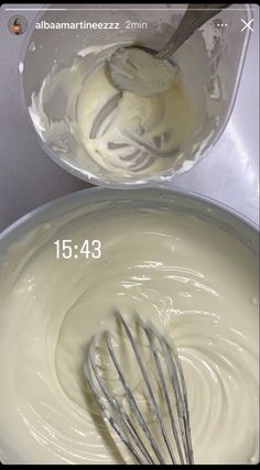 a bowl filled with cream next to a whisk