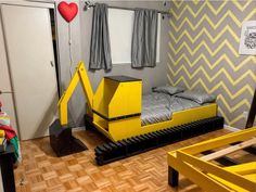 a room with a bed and some yellow boxes on the floor