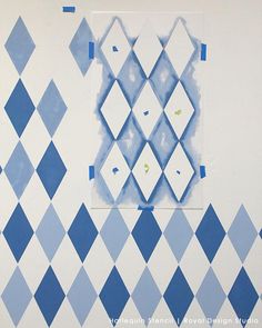 blue and white tile with squares on the wall next to each other in an area that looks like it has been painted