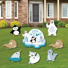 an inflatable pool with penguins and polar bears on the lawn next to a house