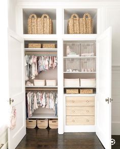 an organized closet with baskets and clothes