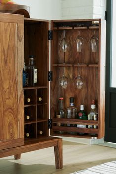 a wooden cabinet with wine glasses in it