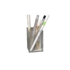 three pens in a clear container on a white background