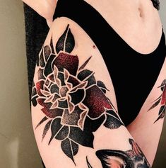 a woman's arm with flowers on it and a bird in the middle of her arm