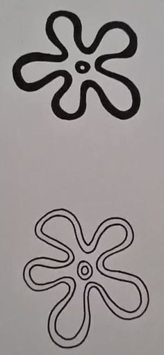 two black and white designs on the side of a piece of paper that has been drawn