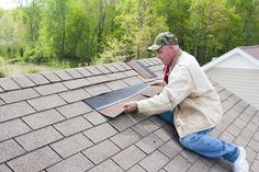 a man is working on the roof of his house