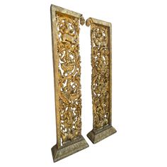 a pair of carved wooden doors with carvings on the front and back panels, both decorated in gold