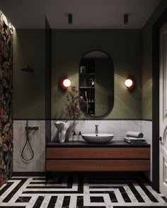 a modern bathroom with black and white tiles on the floor, green walls and wooden cabinets