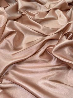 a close up view of a pink satin fabric