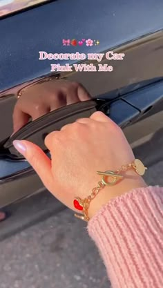 a woman's hand on the wheel of a car