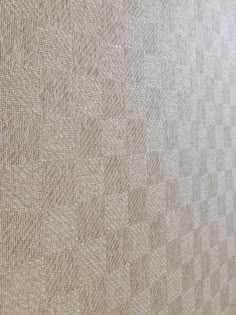 an up close view of the textured fabric on a bed sheet that has been made into a wallpaper