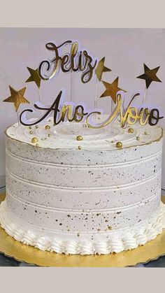 a white cake with gold stars on top that says, feliy are you