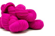 pink skeins of yarn on white background