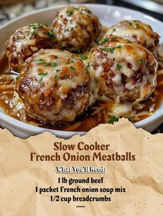 a bowl filled with meatballs covered in gravy on top of a table