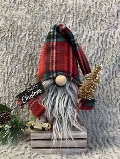 a small christmas gnome sitting on top of a wooden crate