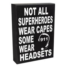 a black box sign with white lettering that says not all superheros wear capes some wear headsets