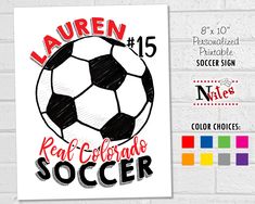 a soccer ball with the name lauren on it is next to a white brick wall