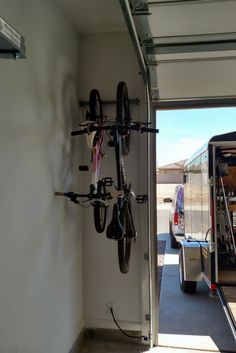 there is a bike rack in the back of a bus with bicycles hanging on it