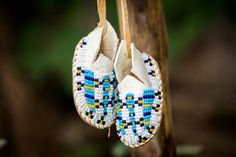 pair of beaded slippers hanging from tree branch