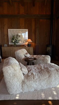 a living room with two couches and a table in the middle, all made out of sheepskin